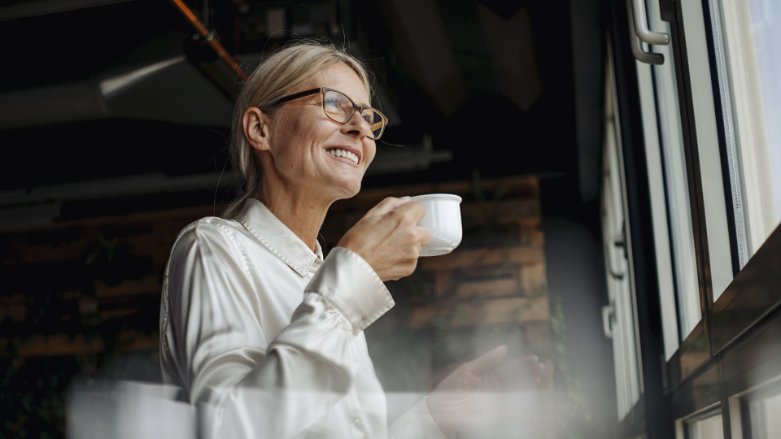 Smiling woman sipping coffee