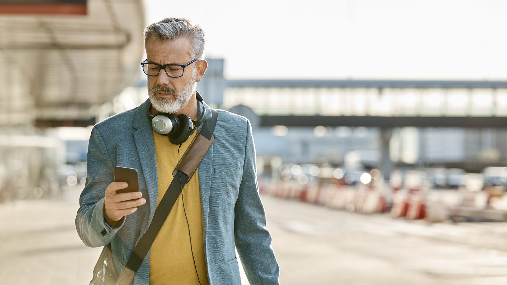 Person looking at cellphone - Why are employers overpaying for retiree healthcare?