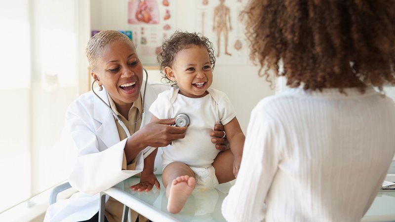 a smiling child and parent at their general practitioner appointment